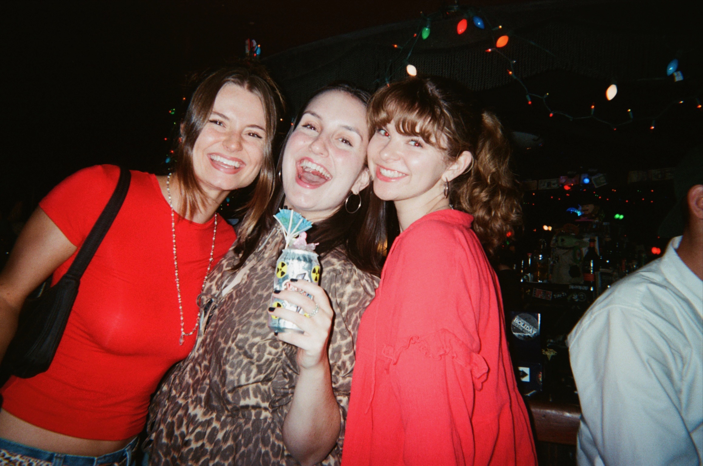 Claire laughing with friends at a bar
