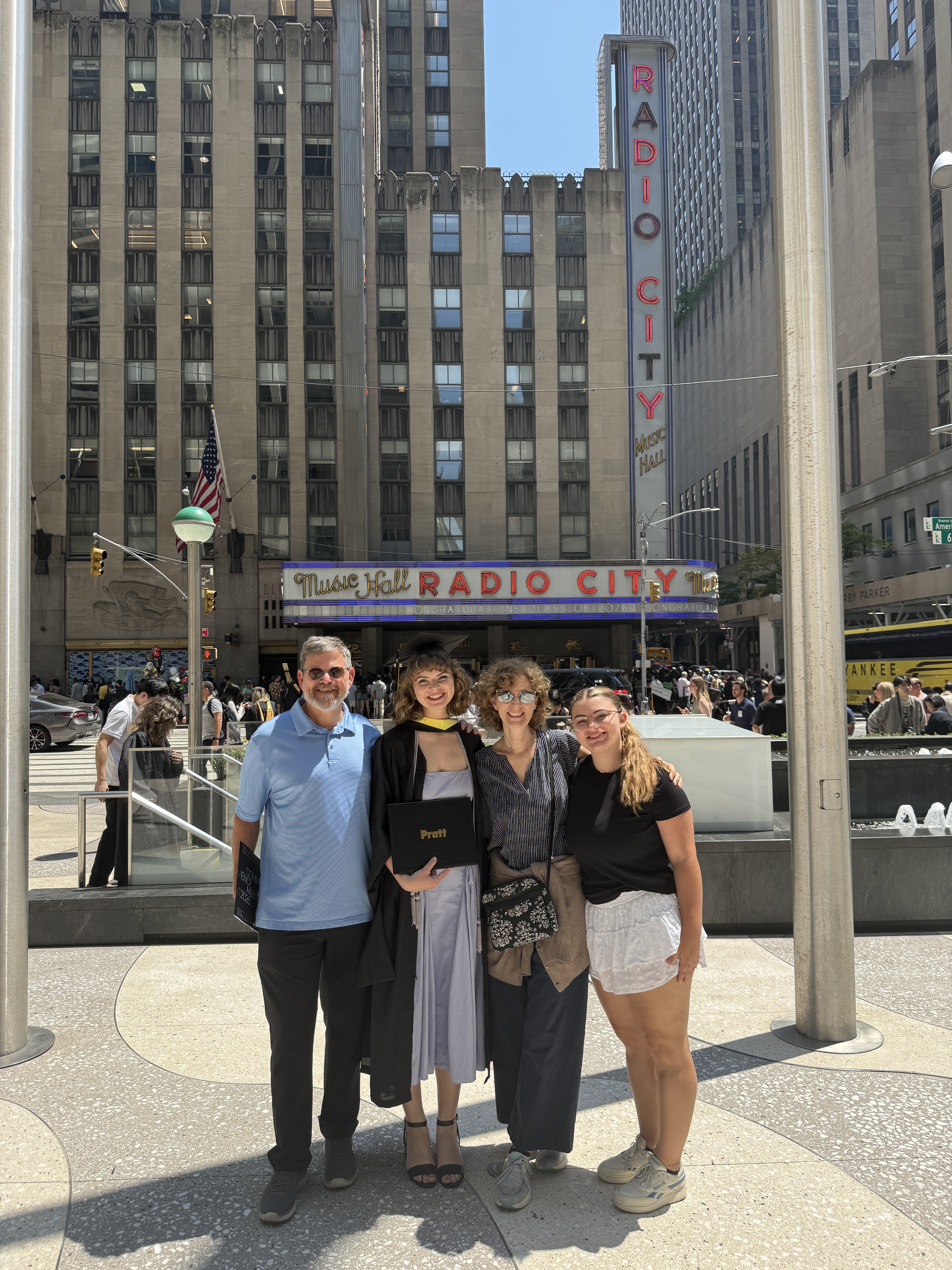 Claire with her family outside Radio City Music Hall on her graduation day