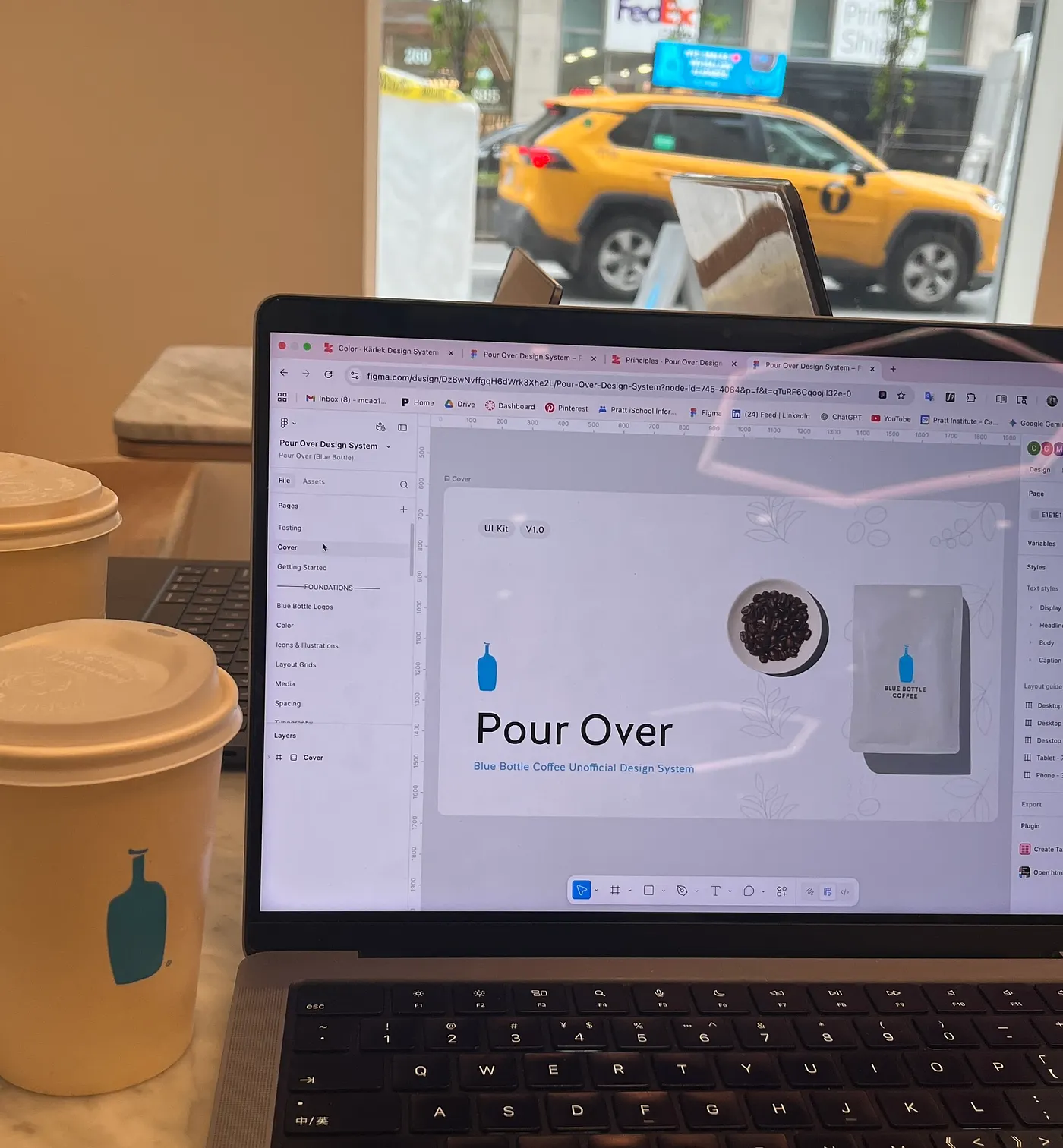 A laptop open to the Pour Over Figma file on a table at Blue Bottle Cafe.